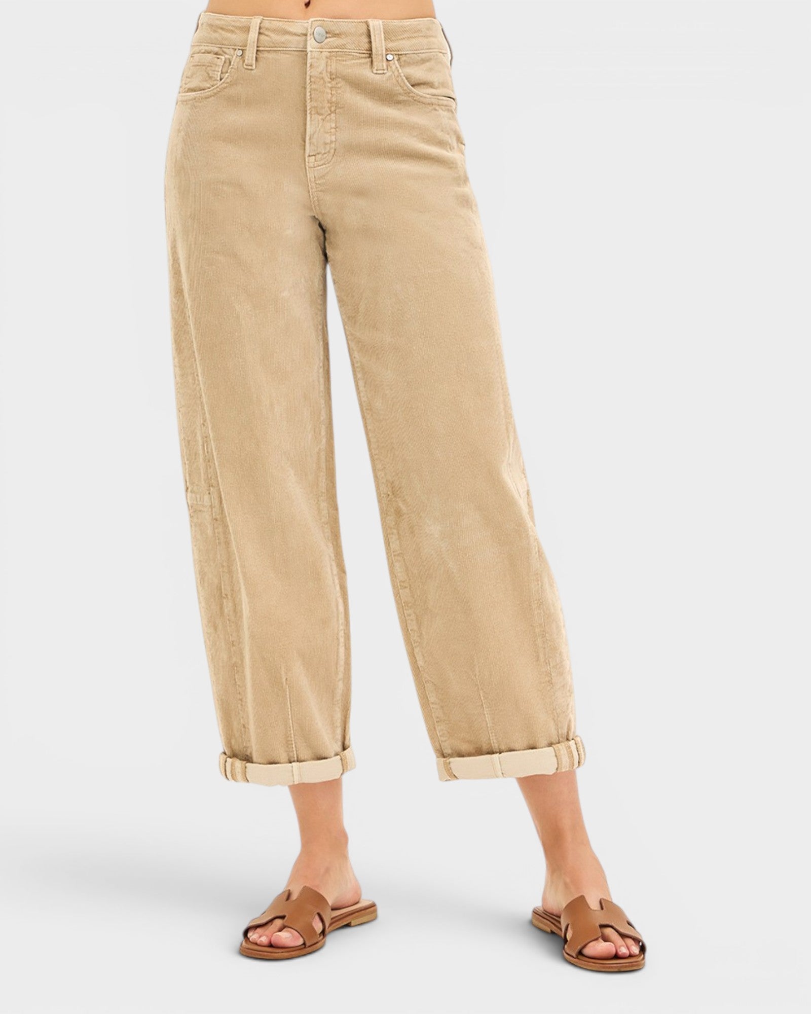 Beige jeans worn by a person on a white background