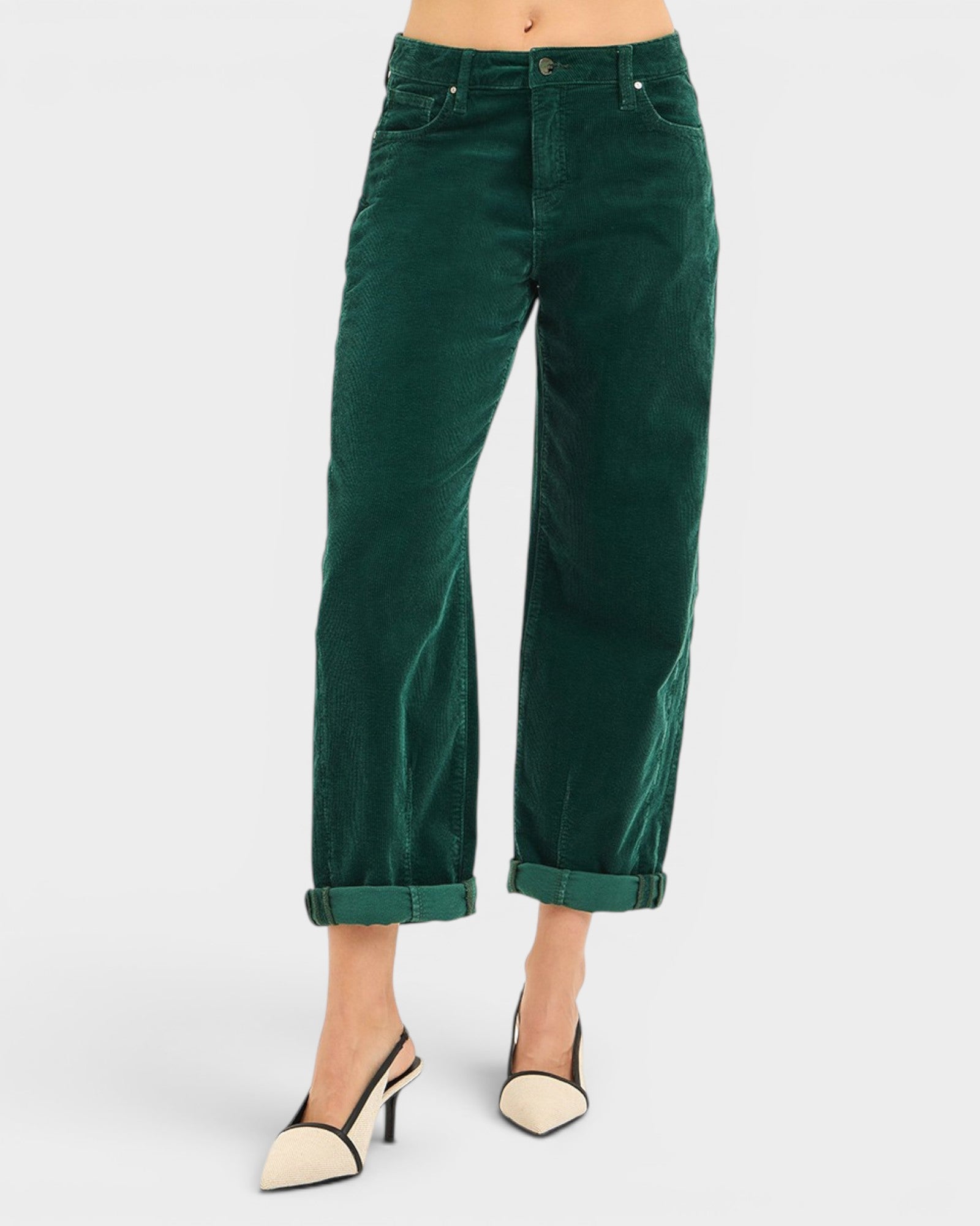 Green corduroy pants worn by a person on a white background