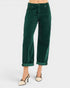 Green corduroy pants worn by a person on a white background
