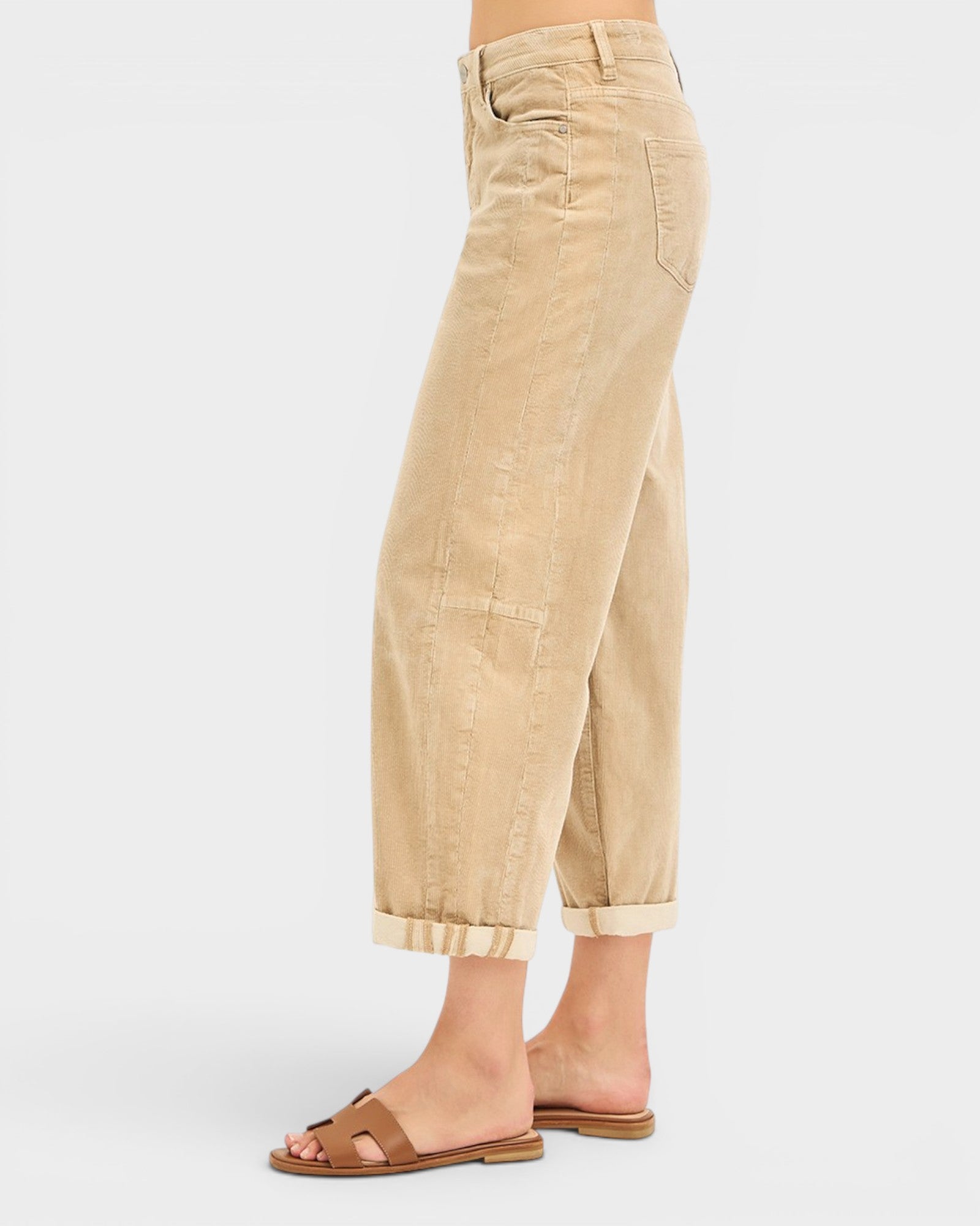 Beige wide-leg pants worn by a person on a white background