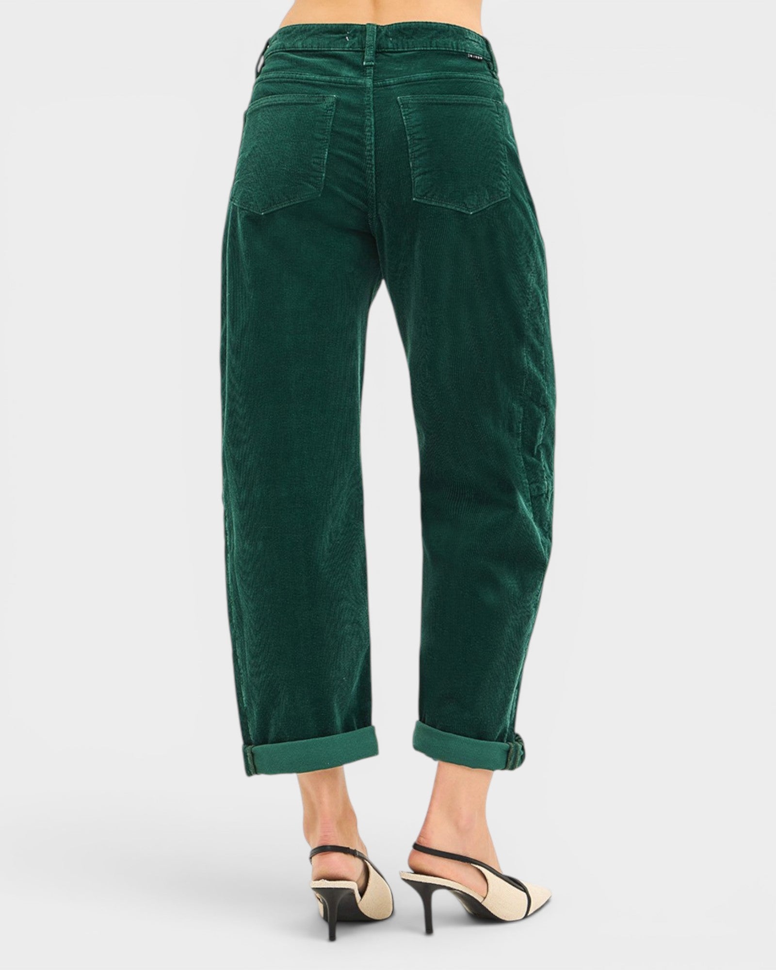 Green pants worn by a person on a white background