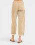 Beige pants worn by a person on a white background