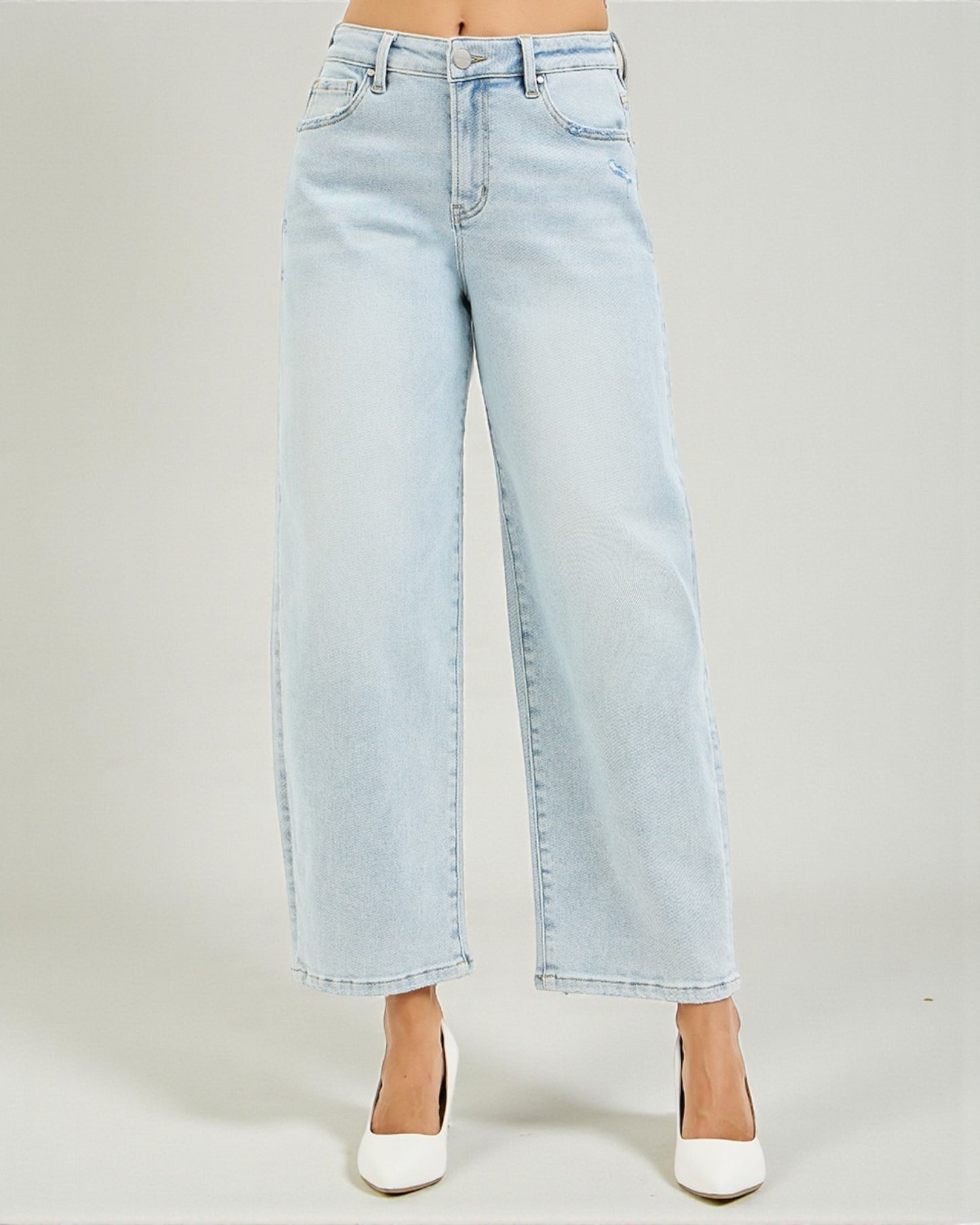 Light blue jeans worn by a person on a plain background