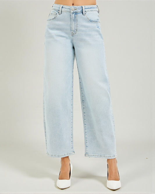 Light blue jeans worn by a person on a plain background