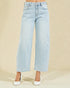 Light blue jeans worn by a person on a beige background