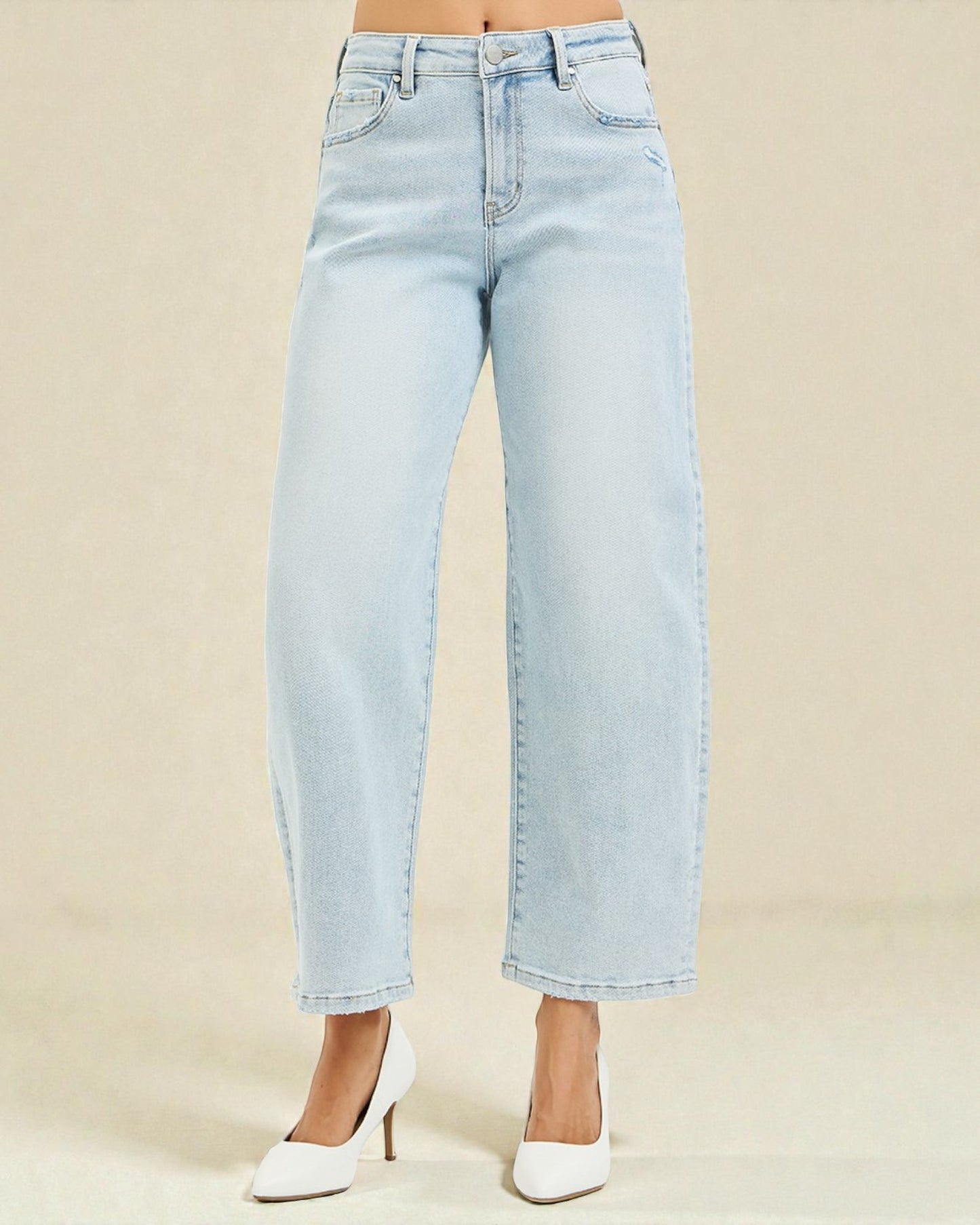 Light blue jeans worn by a person on a beige background