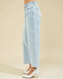 Light blue jeans worn by a person on a beige background