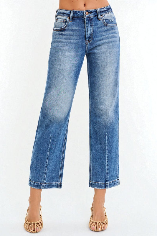 Blue jeans worn by a person on a white background