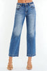 Blue jeans worn by a person on a white background
