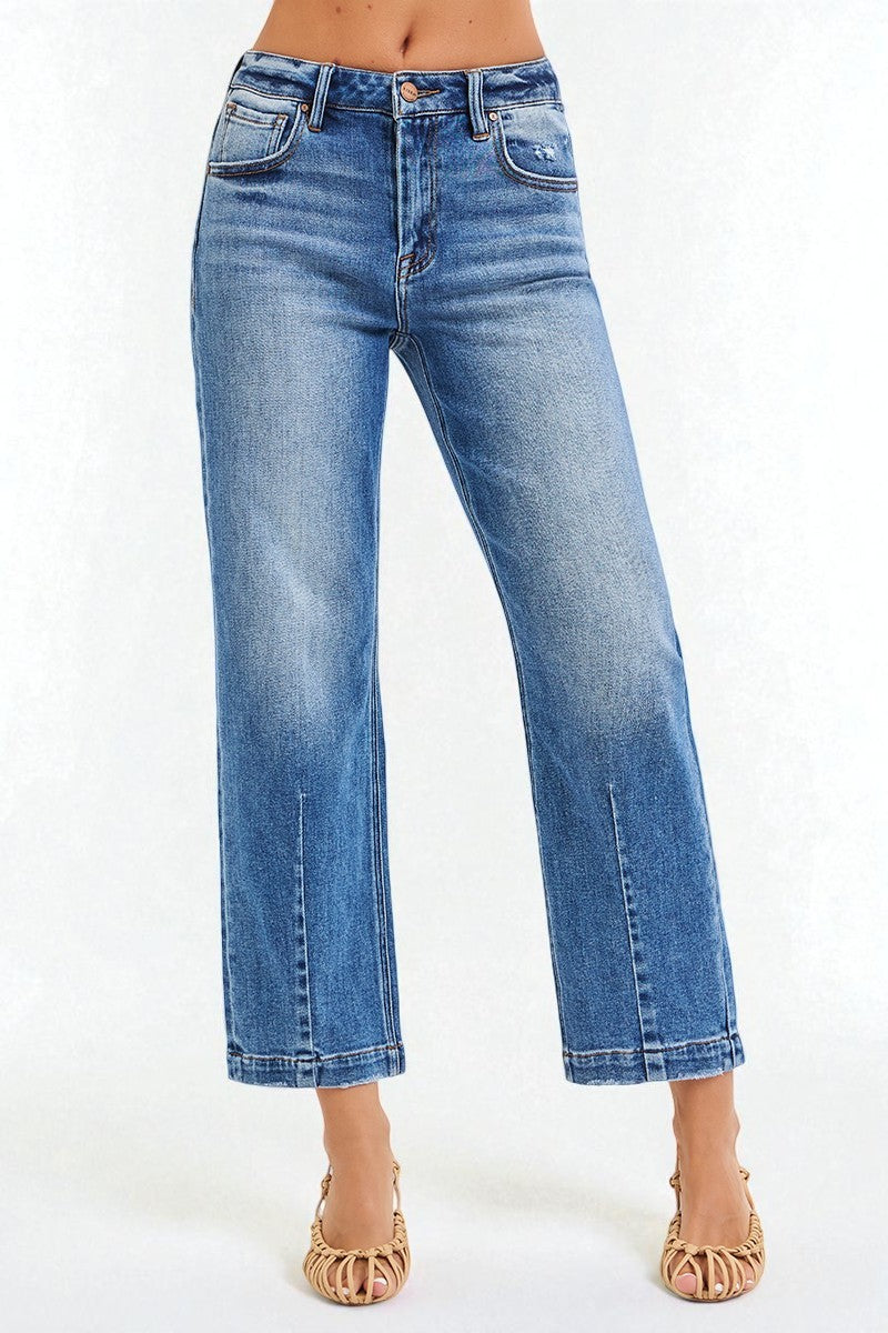 Blue jeans worn by a person on a white background