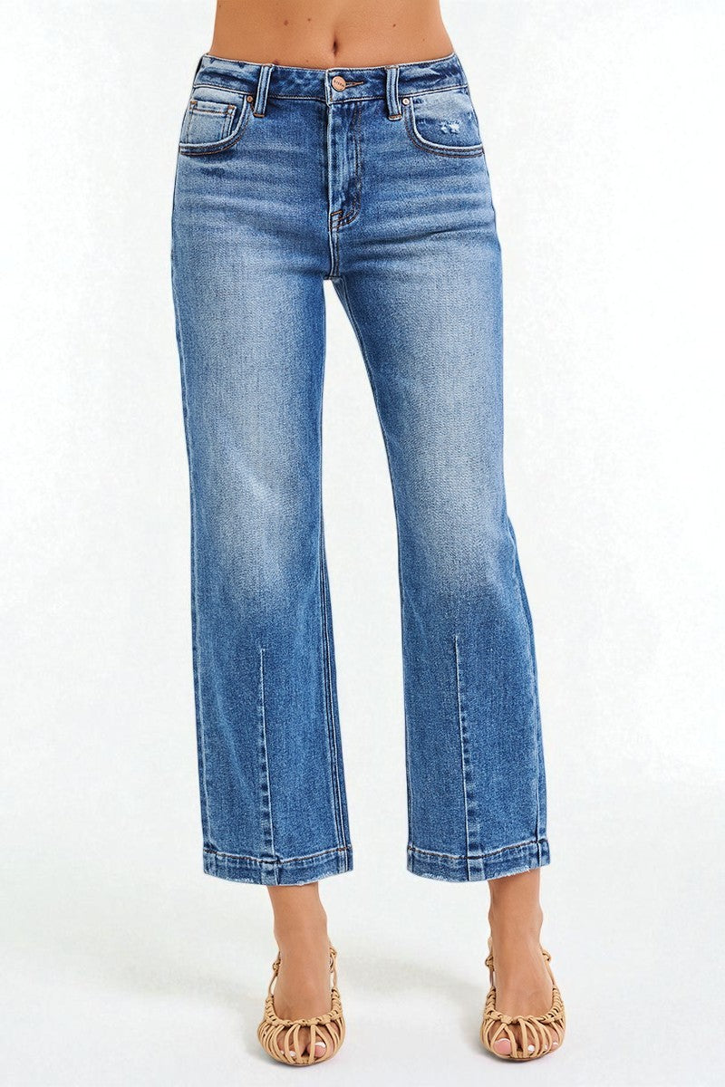 Blue jeans worn by a person on a white background