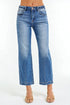 Blue jeans worn by a person on a white background