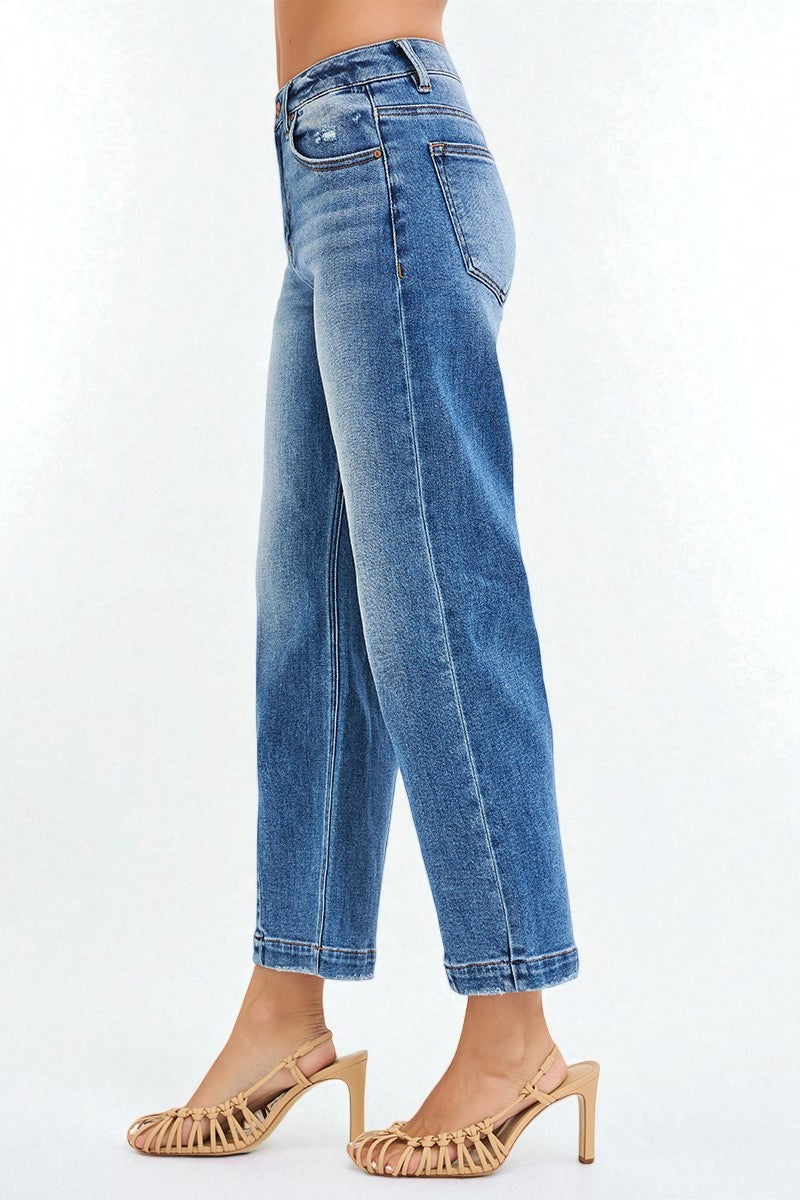 Blue jeans worn by a person on a white background