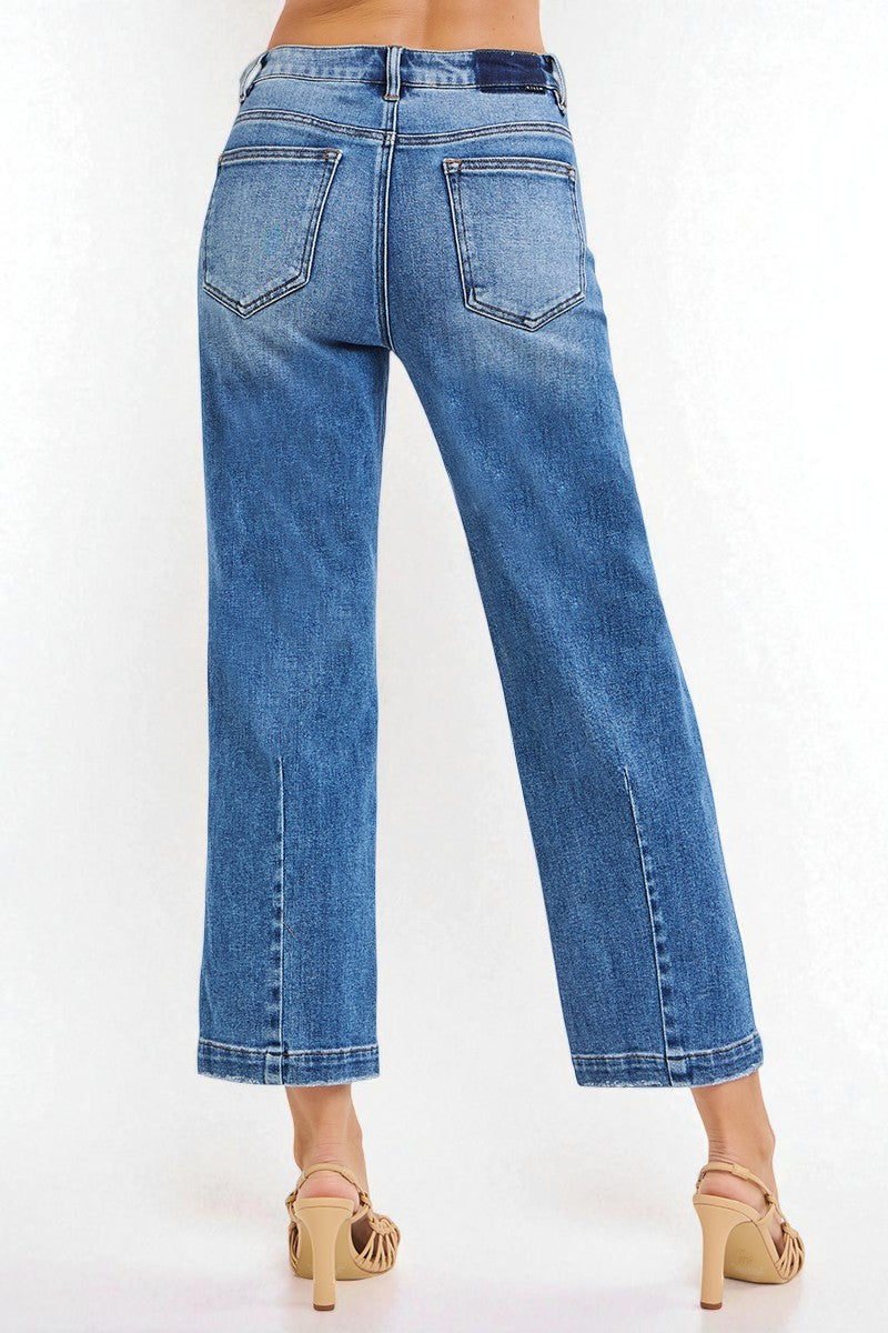 Blue jeans worn by a person on a white background