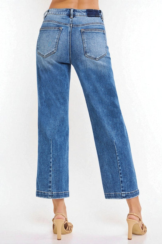 Blue jeans worn by a person on a white background
