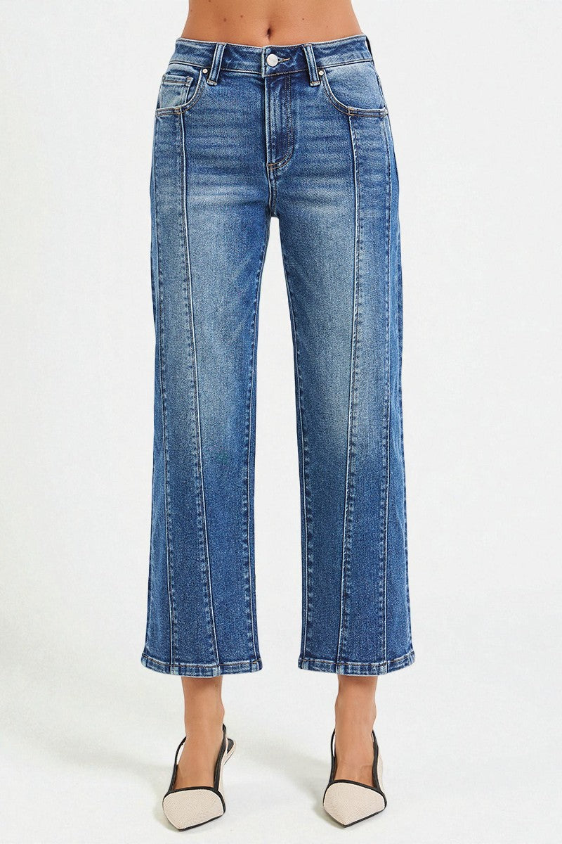 Blue jeans worn by a person on a white background