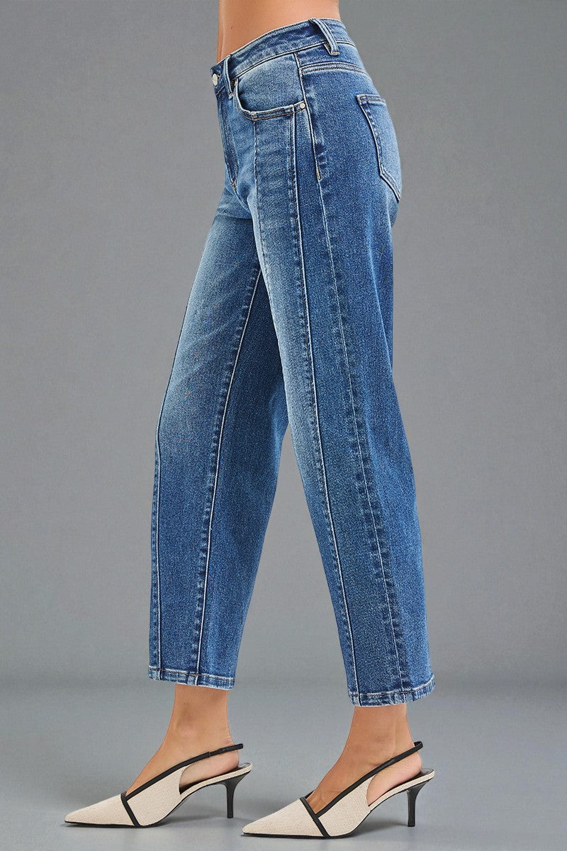 Blue jeans worn by a person on a gray background