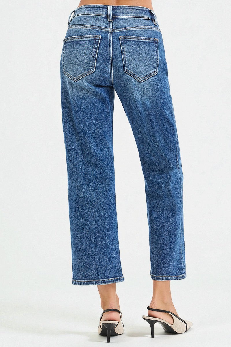 Blue jeans worn by a person on a white background