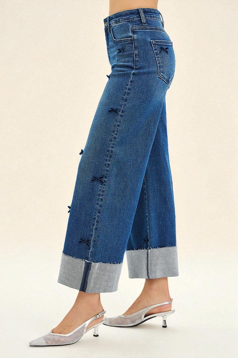 Blue jeans with decorative buttons on a beige background