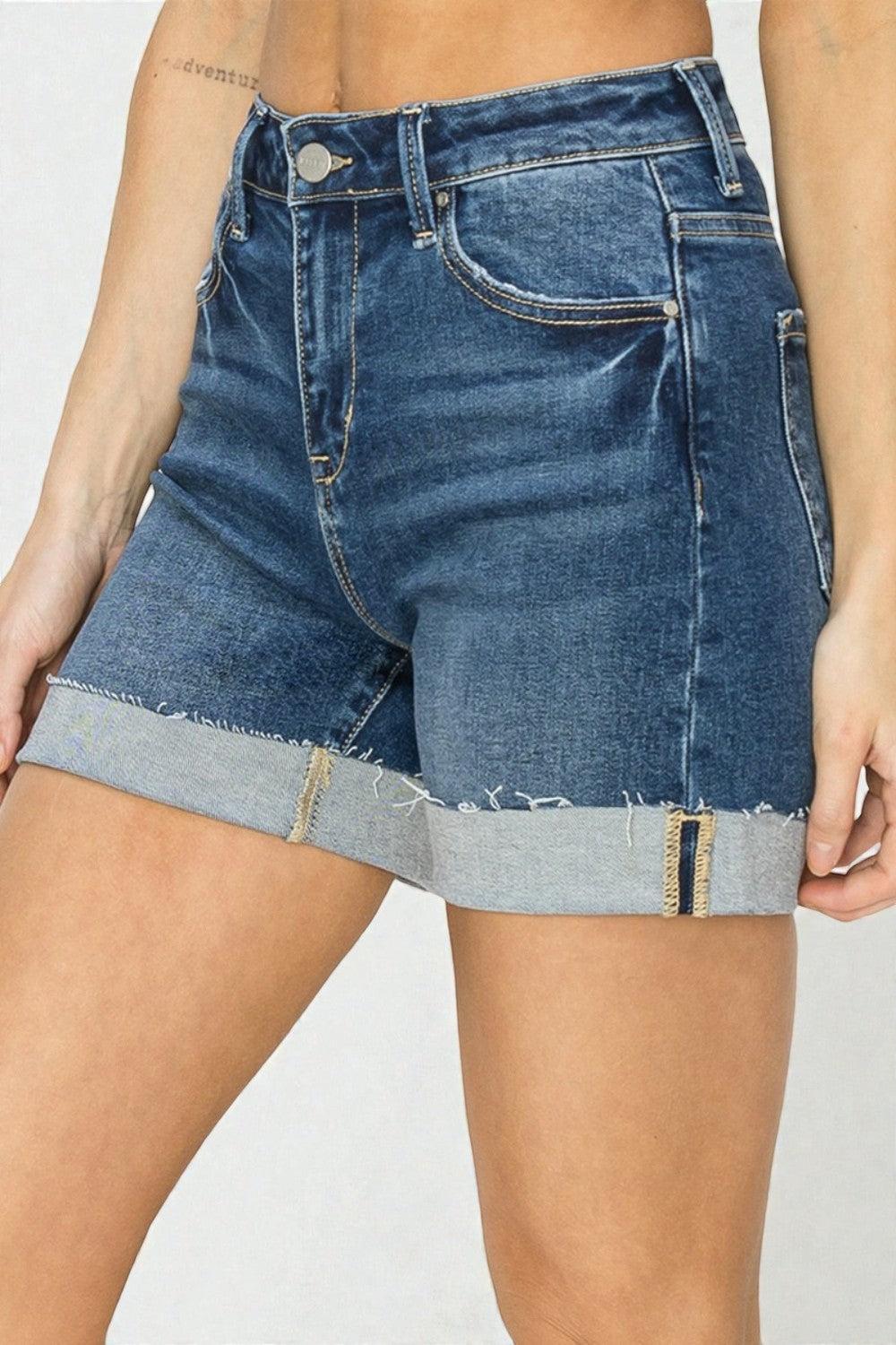 Denim shorts with a frayed hem on a plain background