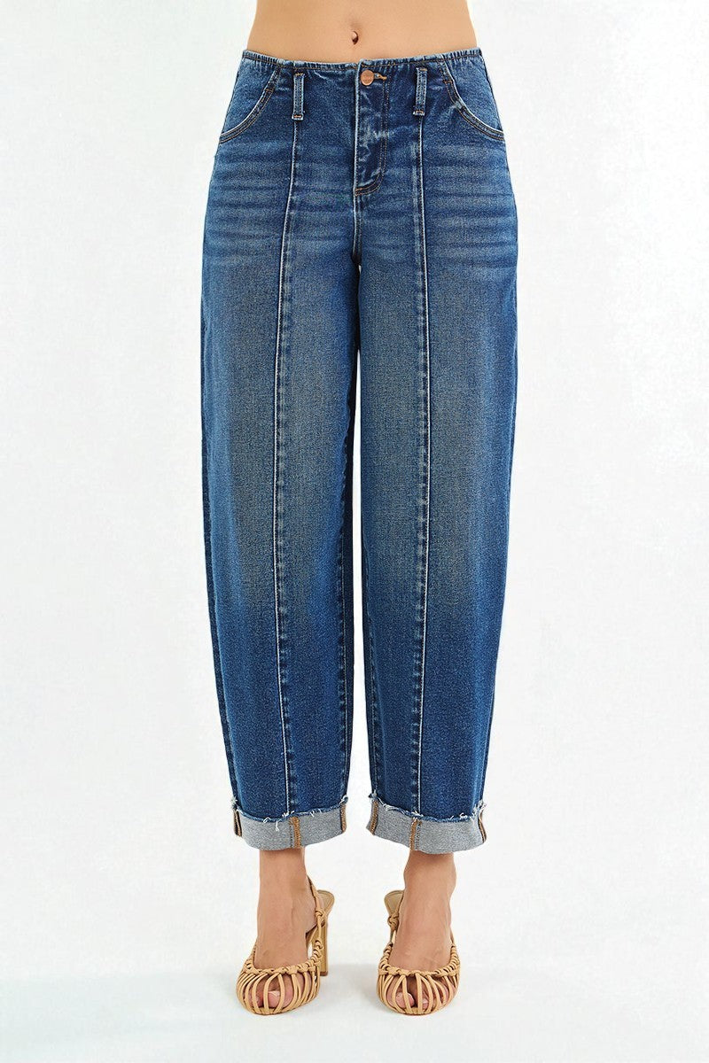 Blue jeans worn by a person on a white background