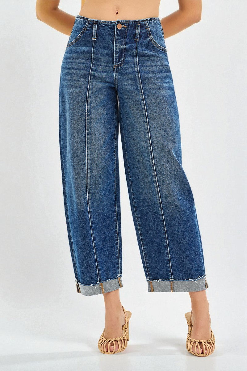 Blue jeans worn by a person on a white background