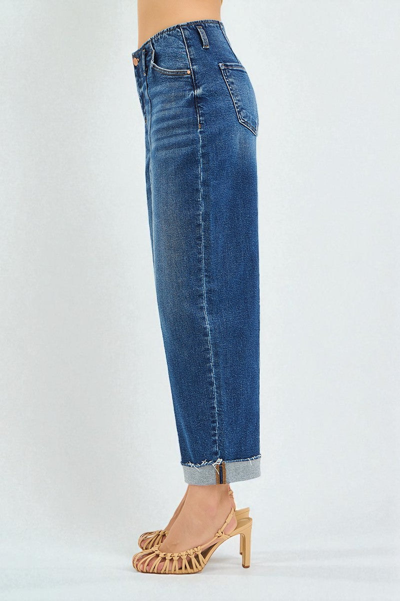 Blue jeans worn by a person on a white background