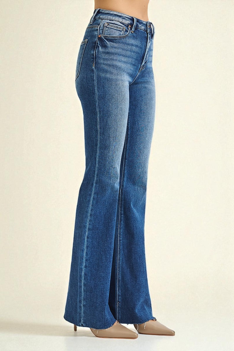 Blue flared jeans on a beige background