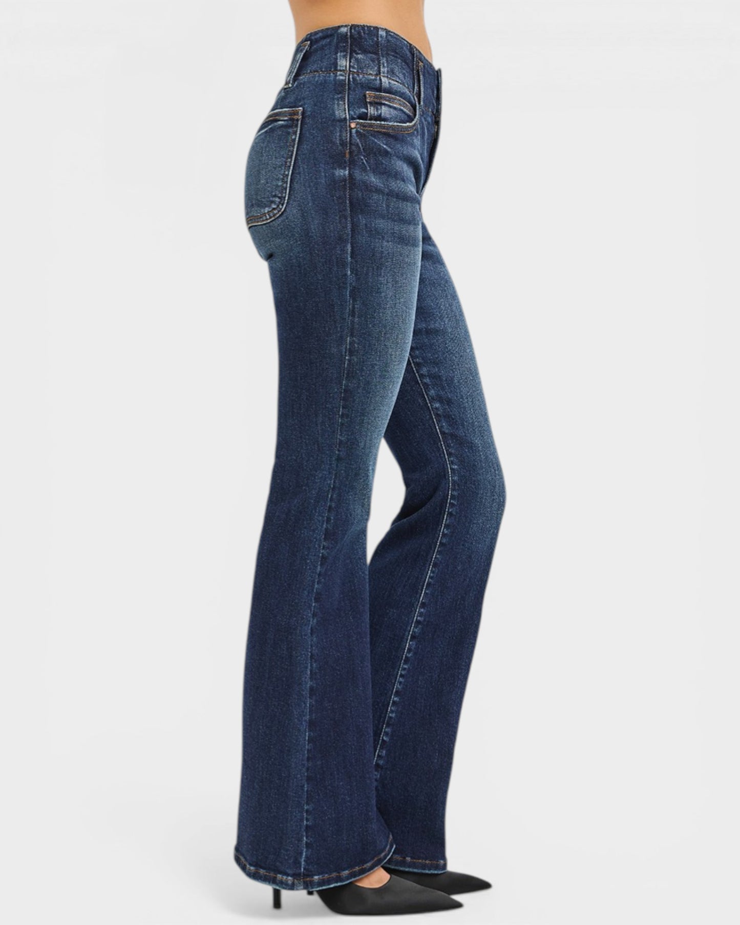 Blue jeans being worn on a white background