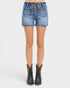 Denim shorts with lace-up front worn by a person on a white background