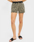 Leopard print shorts worn by a person on a white background