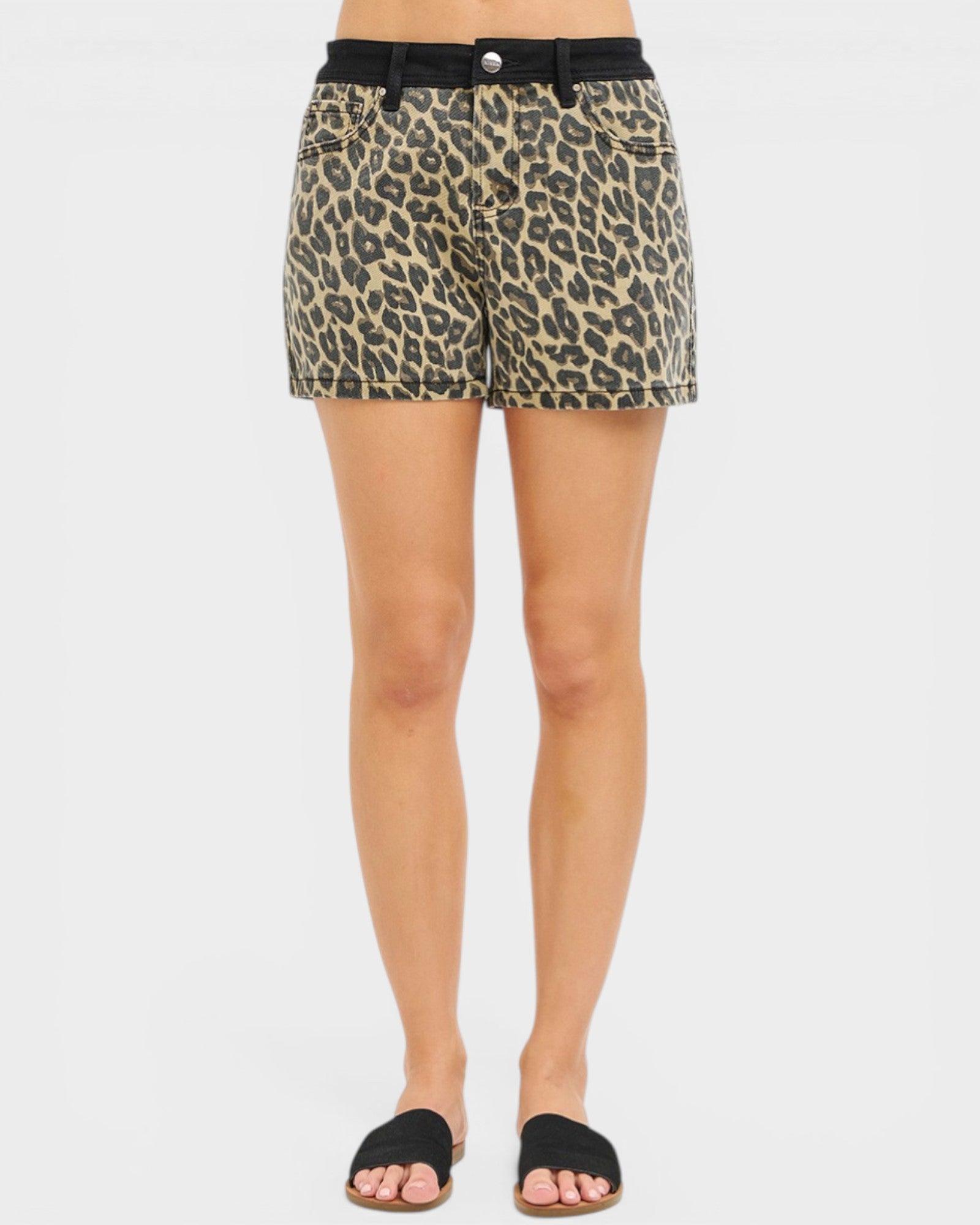 Leopard print shorts worn by a person on a white background
