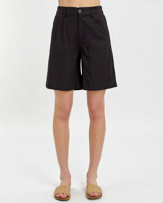 Black shorts worn by a person on a white background