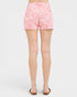 Person wearing pink floral shorts on a white background