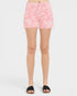 Person wearing pink floral shorts on a white background