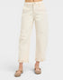 Person wearing cream-colored jeans on a white background