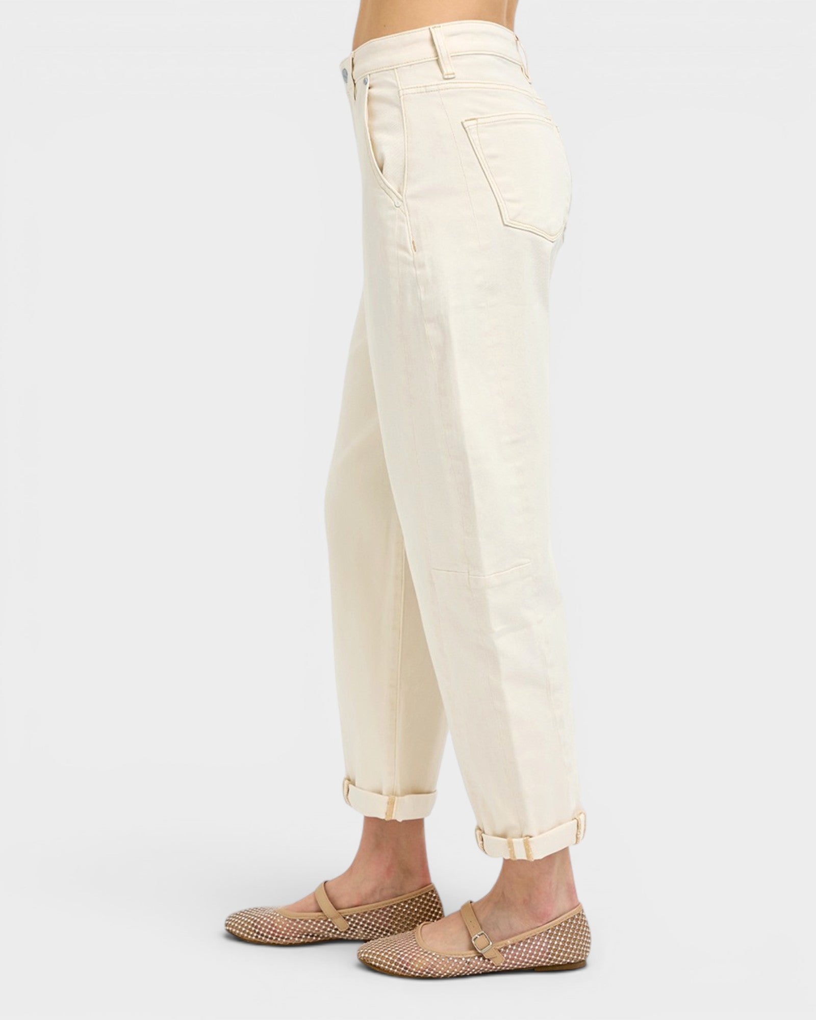 Beige pants worn by a person on a white background