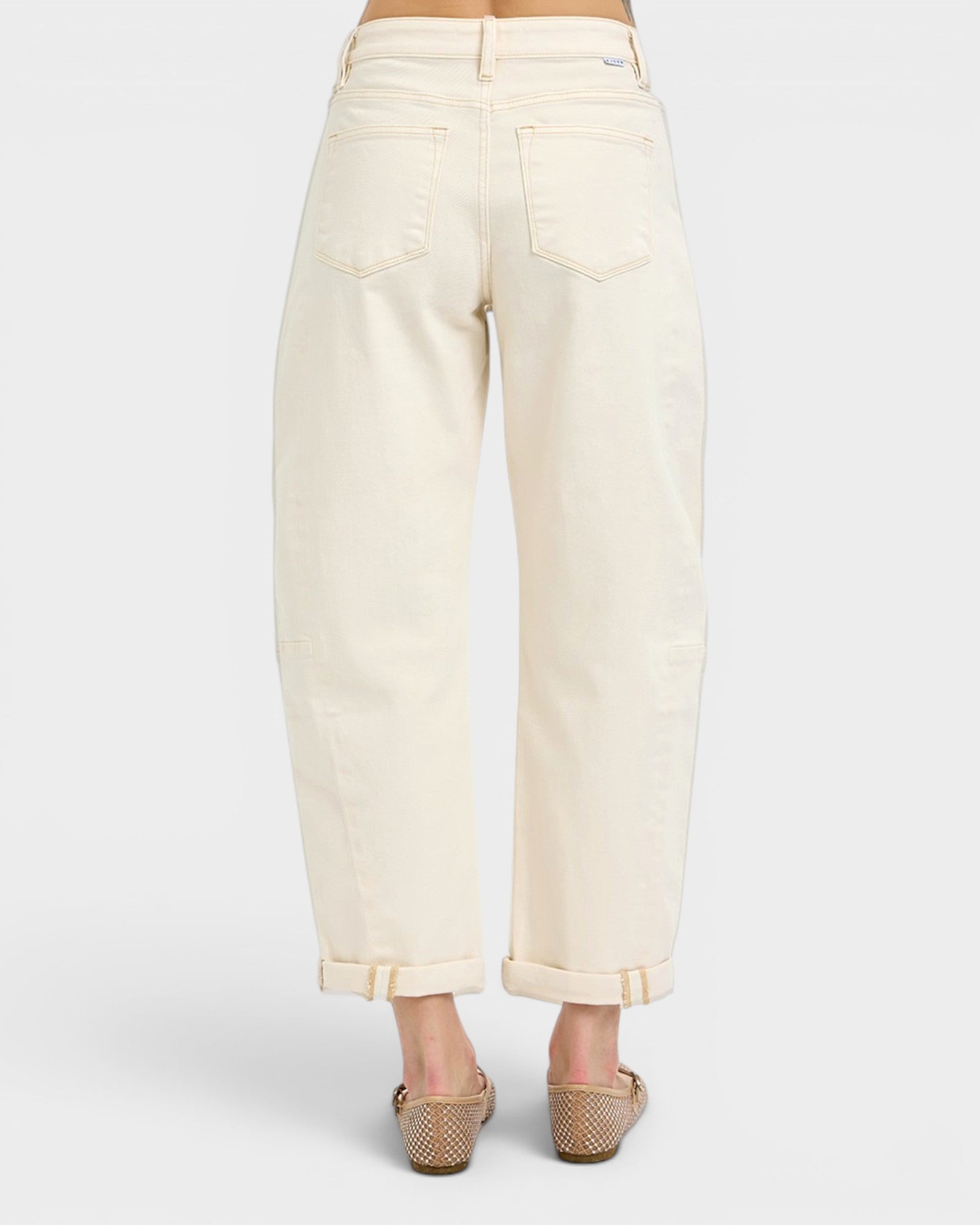 White pants worn by a person on a white background