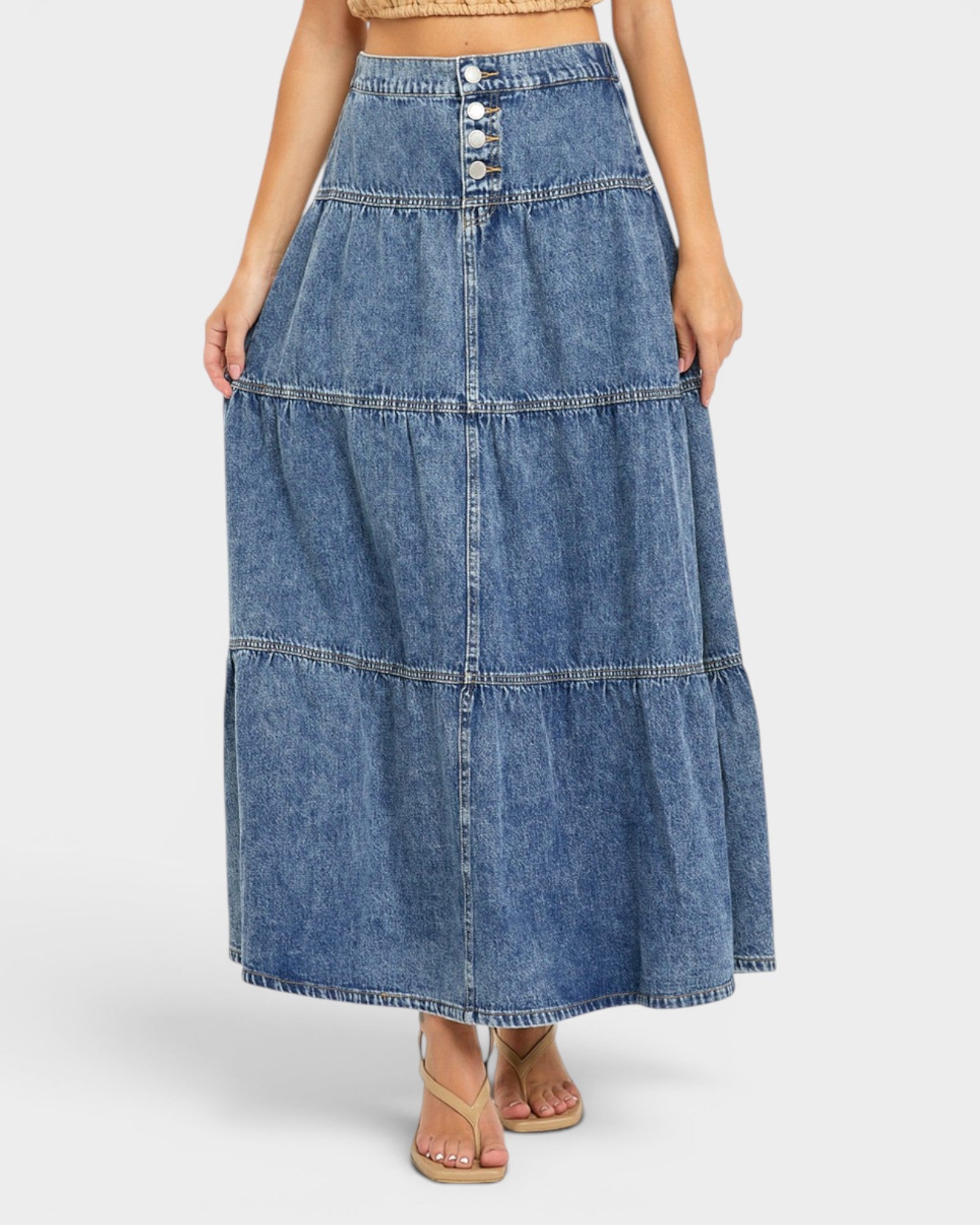 Denim skirt worn by a person on a white background