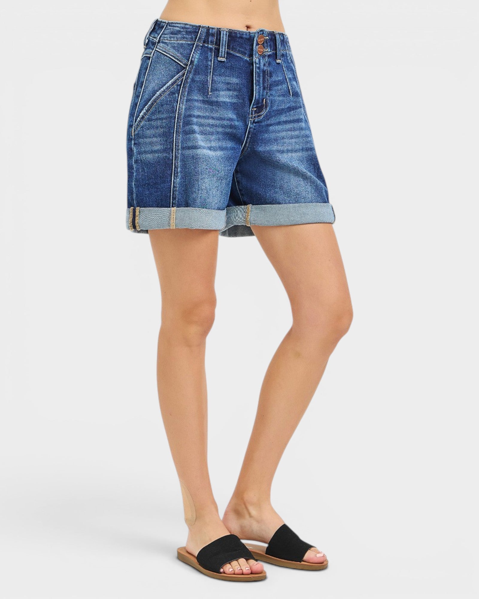 Person wearing blue denim shorts on a white background