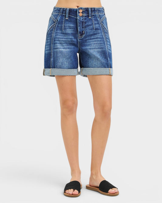 Denim shorts worn by a person on a white background