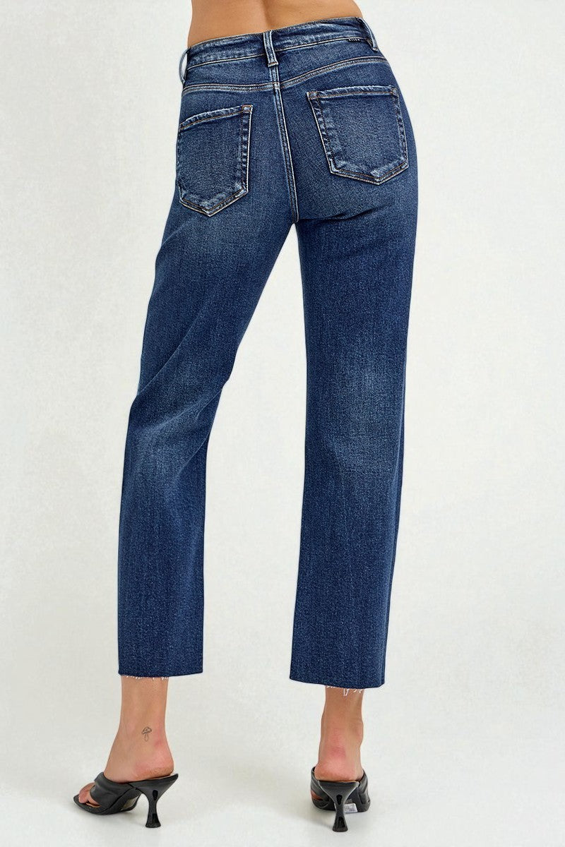 Blue jeans worn by a person on a white background