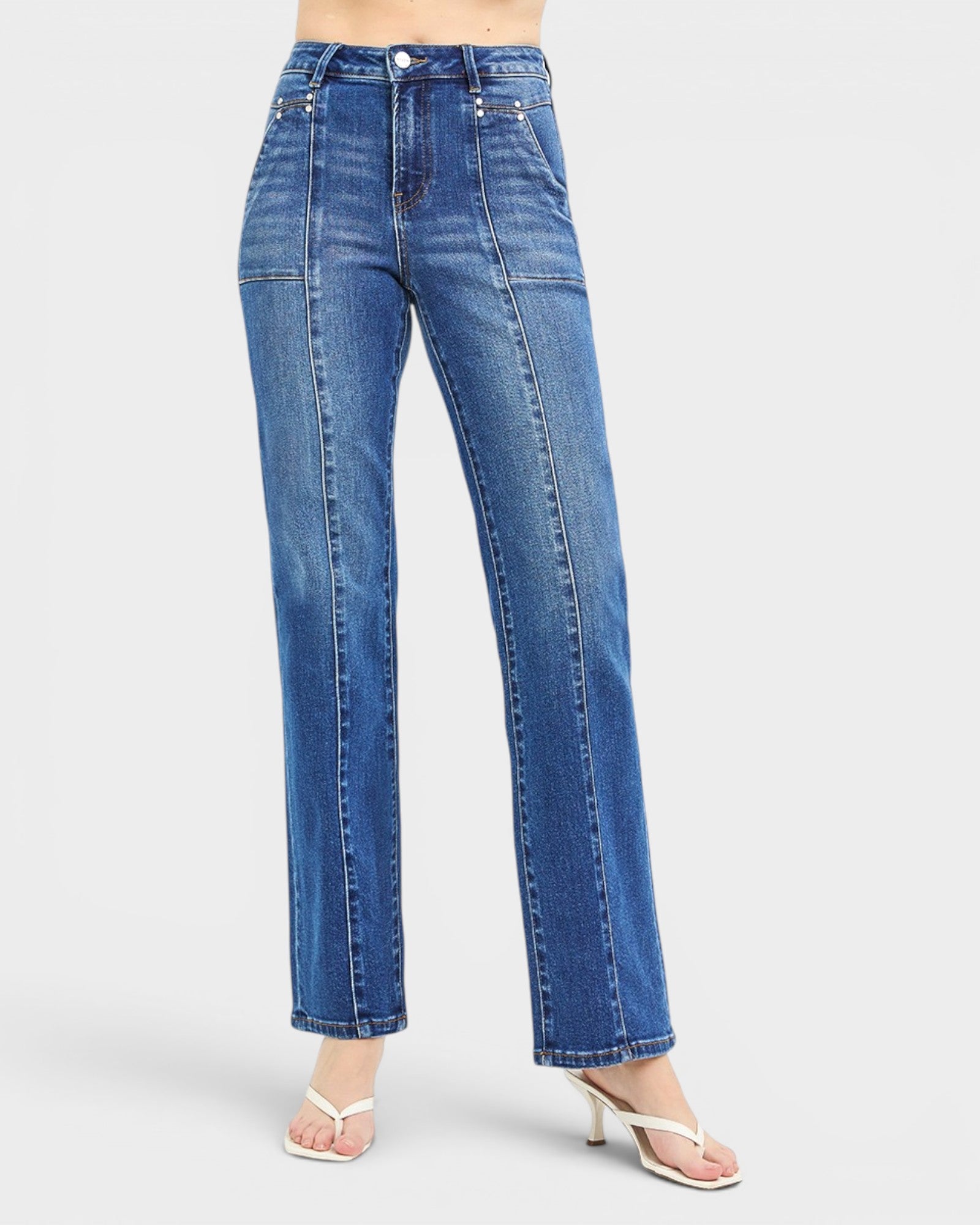 Blue jeans worn by a person on a white background