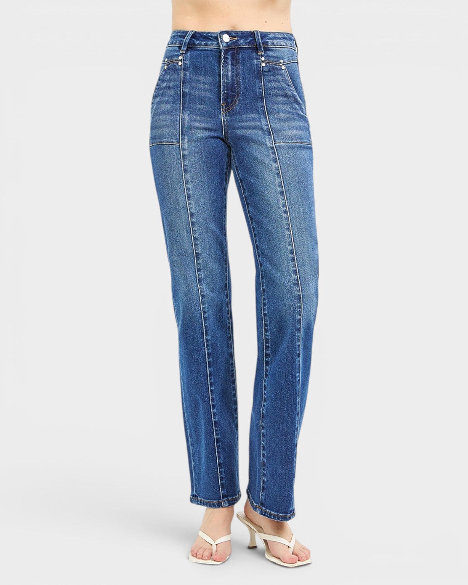 Blue jeans worn by a person on a white background