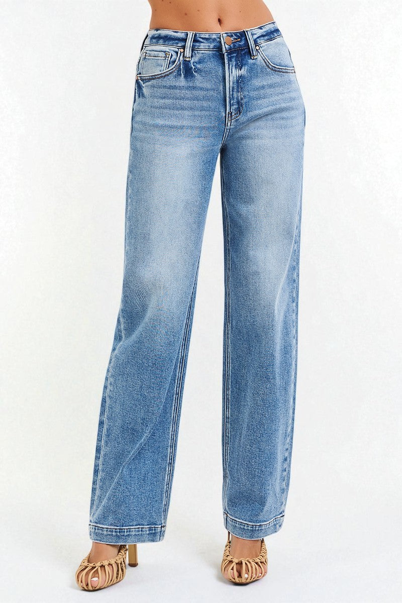 Blue jeans worn by a person on a white background