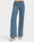 Blue patterned jeans worn by a person on a white background