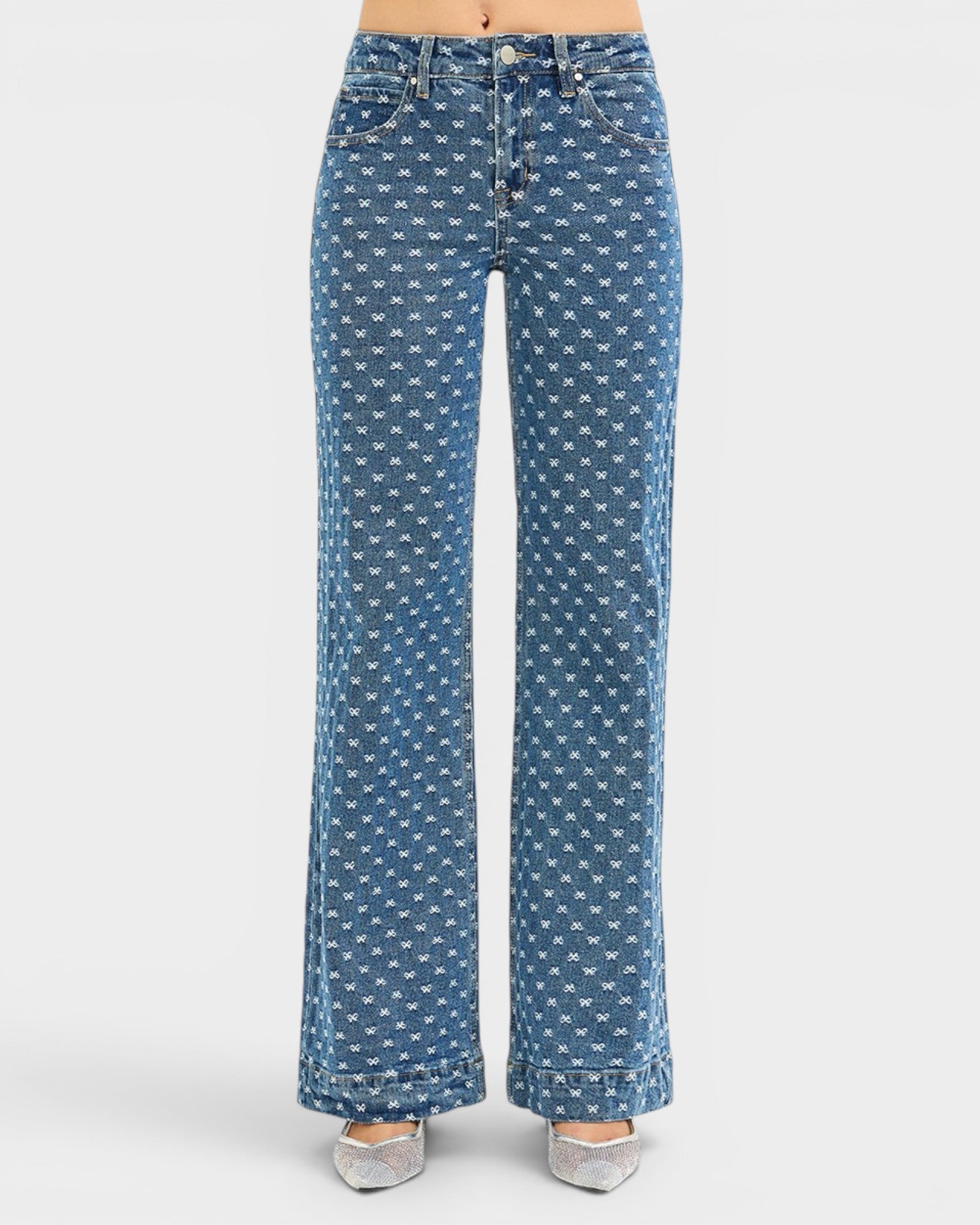 Blue jeans with white bow pattern on a white background