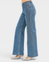 Blue denim jeans with white pattern worn by a person on a white background
