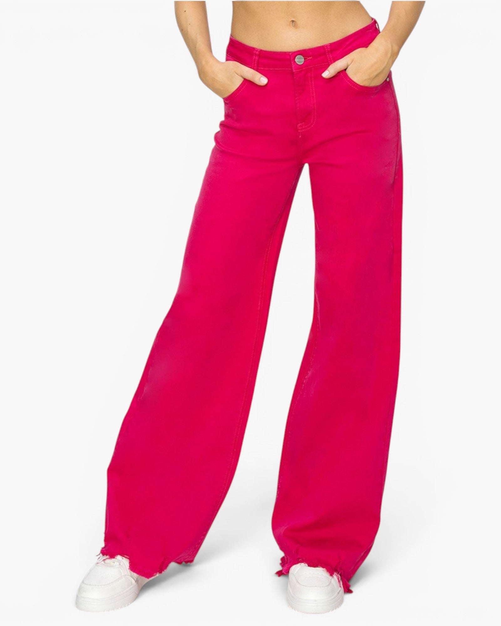 Bright fuchsia pink wide-leg jeans modeled from the waist down, paired with white sneakers, on a clean white background.