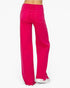 Bright pink wide-leg jeans with raw, frayed hems, shown from the back on a model against a white background.
